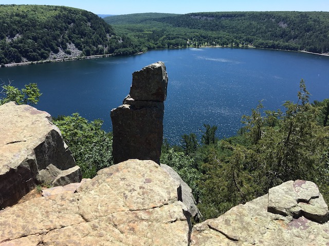 Photo of rocky outcroppings over a lake
